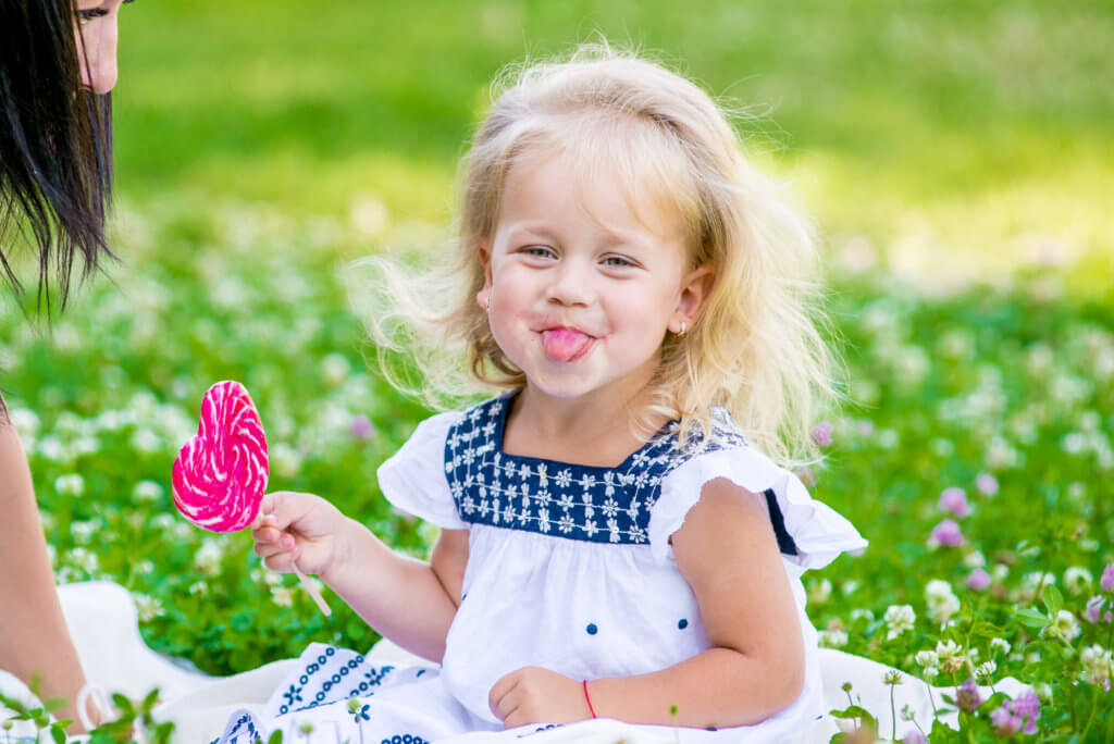 Valentine’s Day and Divorce - Look at this cute little blond with a heart lollipop. Let us focus on the positives in our life